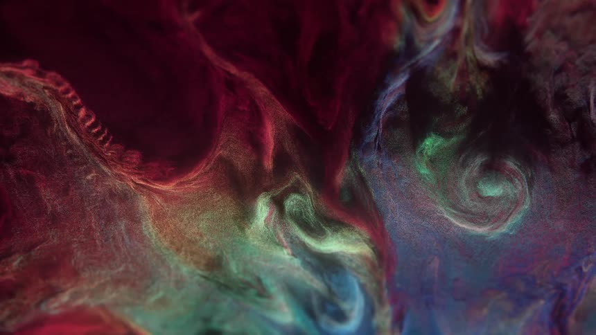 A closeup of an abstract texture featuring red green and blue liquid elements