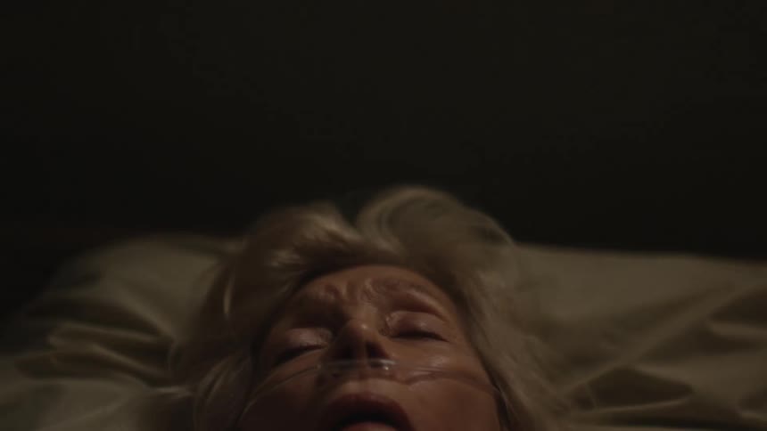 Portrait of an elderly woman sleeping in bed with a nasal cannula