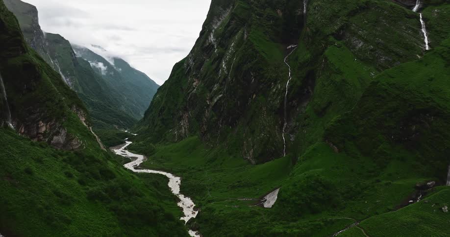 Aerial of a stream in a valley with mountains