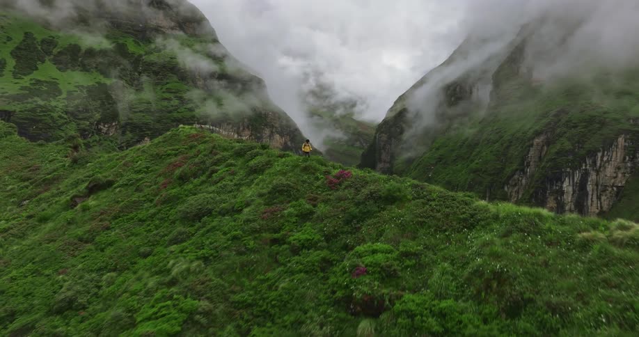 A man is hiking on the peak of the mountain