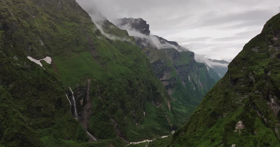 An aerial view of a mountain range covered in moss