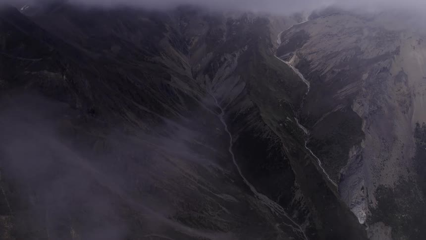 Aerial panorama at cloud level in a natural area with mountains and slopes