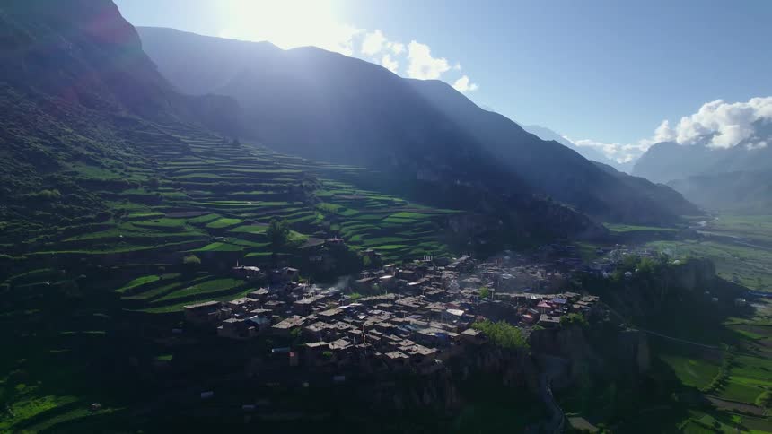 Aerial view of houses built on top of mountains amidst nature