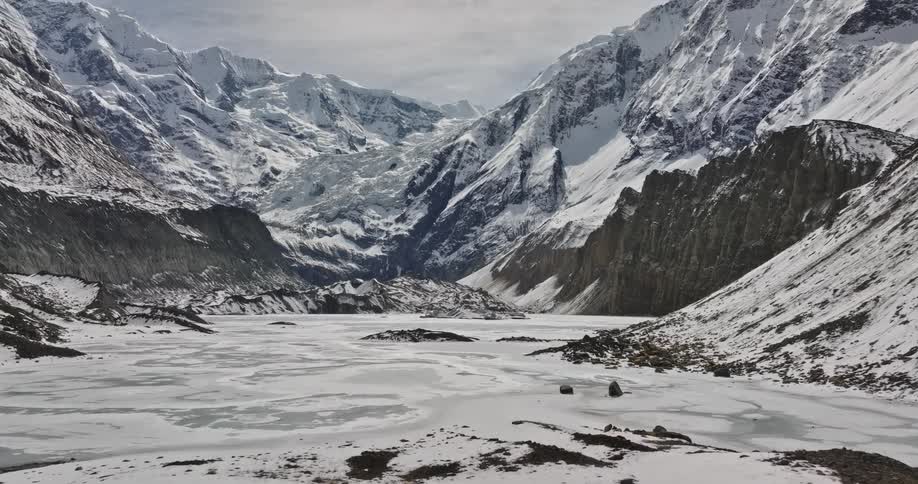 A region close to mountains with a lot of snow covering the ground