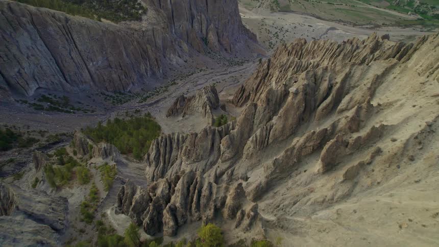 A valley in the middle of rocky mountains with pointy formations
