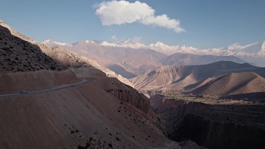A car drives on the mountain road