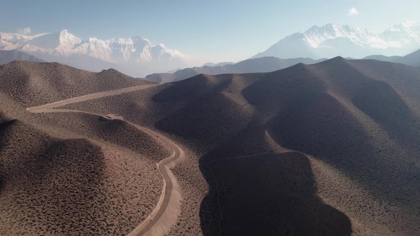 A dirt road across desert dunes