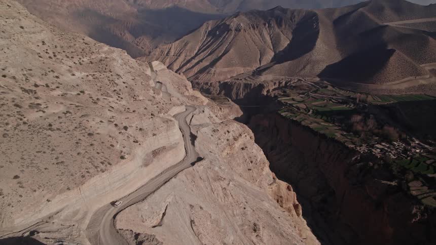 A car drives on the mountain road