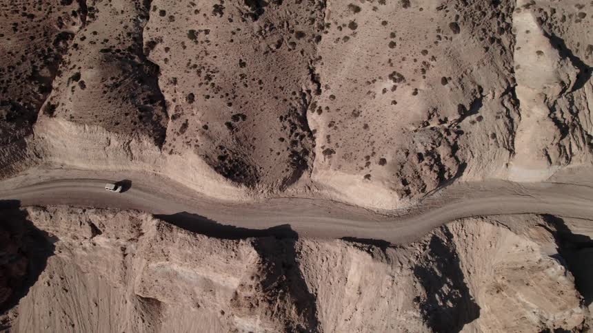 A car driving on a street in a desert region