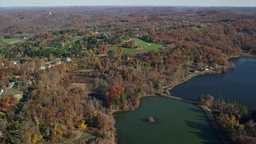 An aerial view of a rural community in the woods close to the river bank