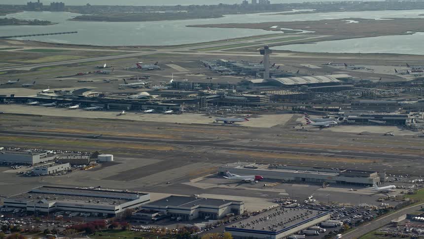 An airport airfield with hangers and airplanes