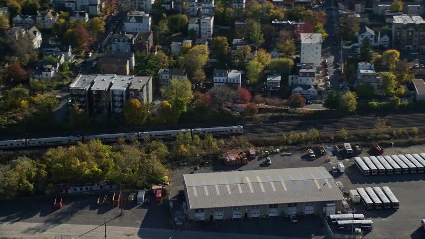 Aerial view of a suburban area with a passing train