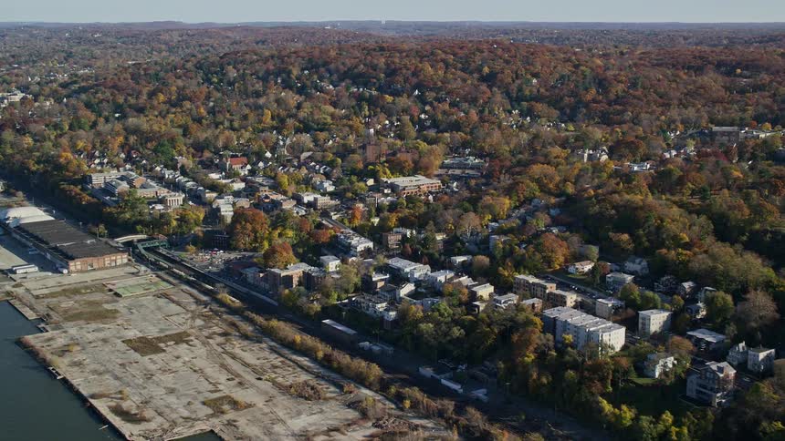 Aerial panorama of a residential city by the seaside with extensive vegetation