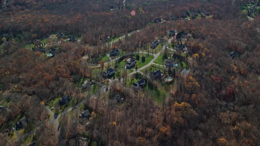 An aerial view of a rural community close to the woods and river