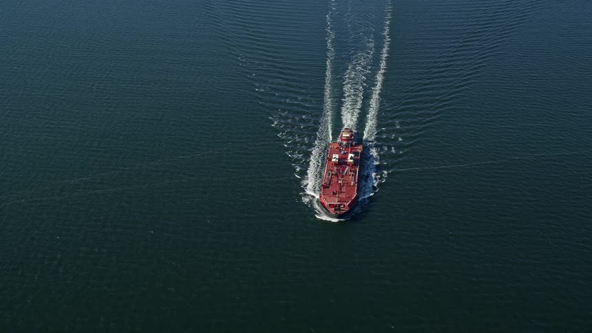 A cargo ship sailing on the ocean surface