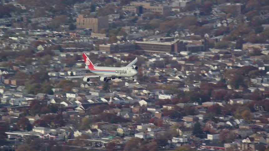 Aerial view of a commercial airplane landing in the city