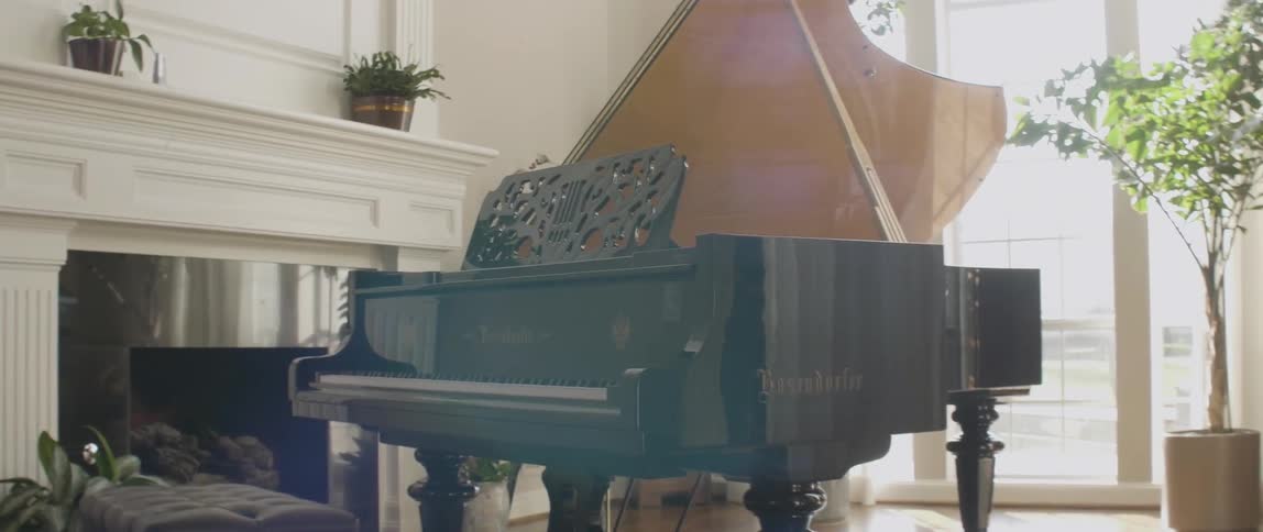 A piano sits in a large well lit room