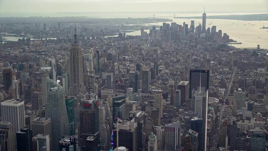 A metropolitan city and behind it there is a coast with sea