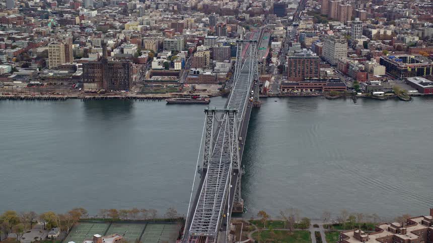 Aerial view of a metropolitan city with a bridge connecting the cities and a central sea