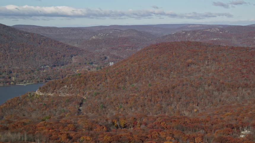 An aerial view of mountainous woods close to the river