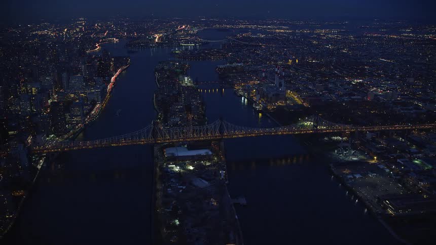 Aerial view of a metropolis by the seaside with a massive bridge connecting the cities