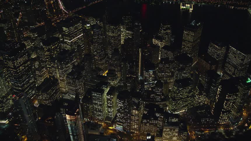 A large city center at night and the lights in the buildings are on