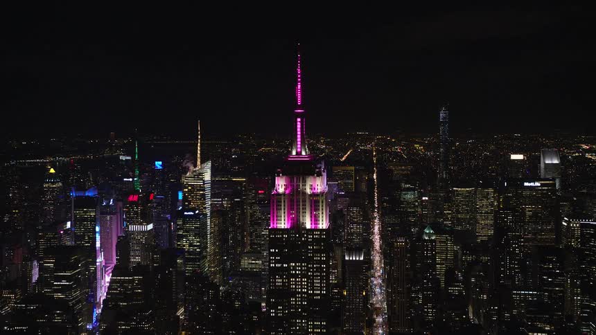 A pink glowing tower in the middle of the metropolis