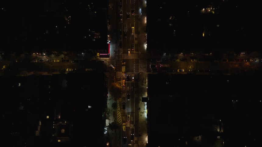 Aerial view of cars driving in the city streets at night