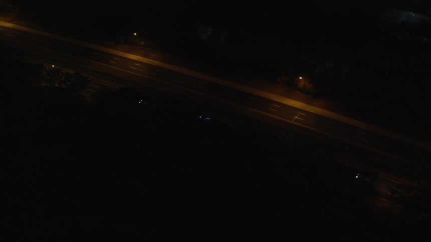 Aerial of moving cars on a metropolitan road at night