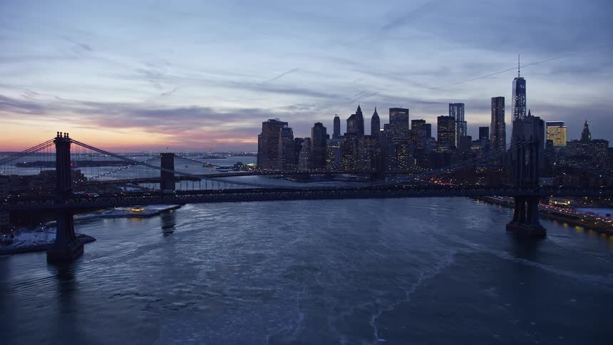 Aerial view of the new york city skyline and bridges at sunset