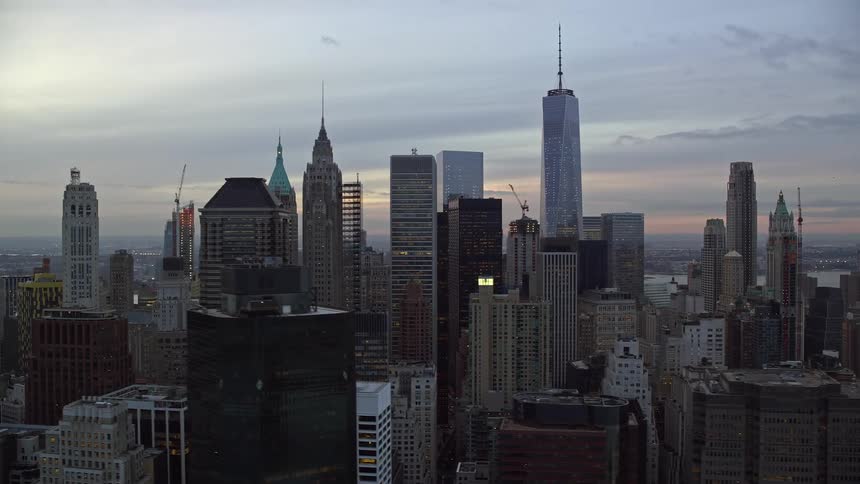 Skyline of a city with large block towers during dawn