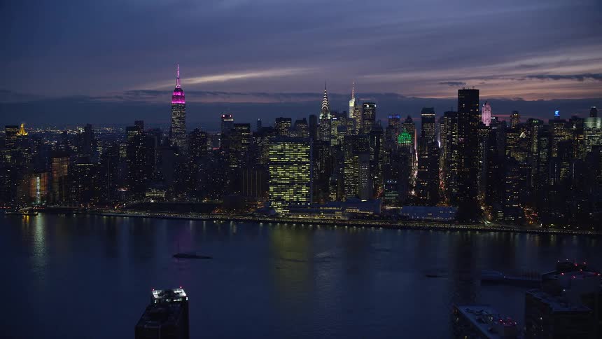 New tork city with skyscrapers and river at night