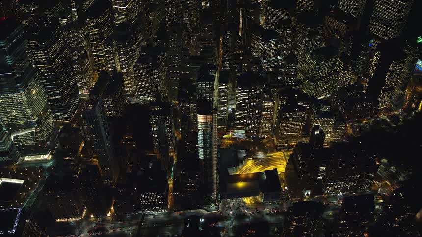 Aerial view of a metropolitan city illuminated by its buildings during the night