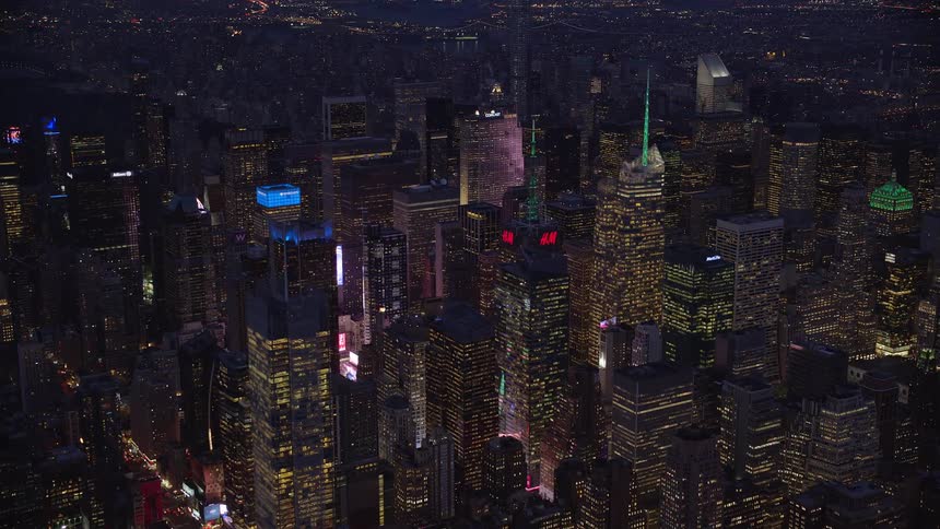 Skyline of a metropolitan city with skyscrapers illuminated at night