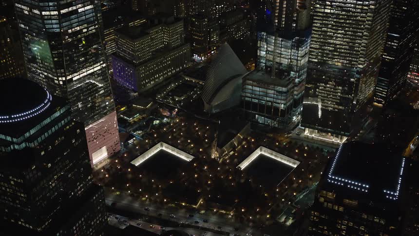 A metropolitan city with huge buildings and lights on one night