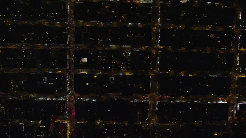 Traffic runs on the city streets at night