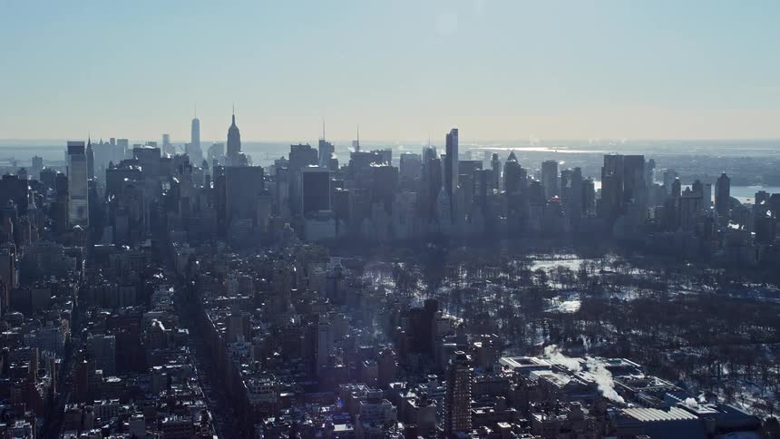 A panoramic view of a metropolitan city with huge buildings and a sunny light