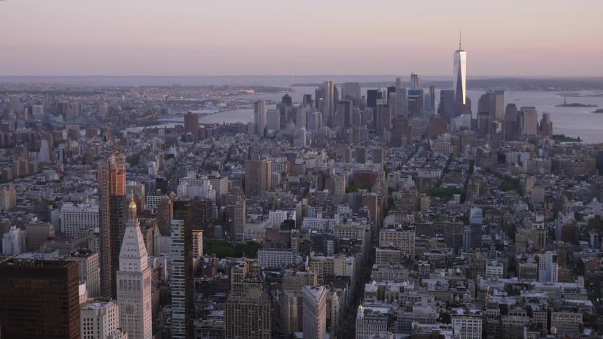 A large city with many skyscrapers and tall buildings by a body of water