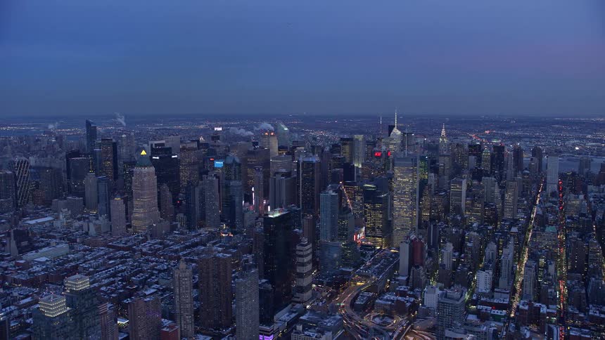 Panorama of a metropolis with the evening sky and illuminated skyscrapers