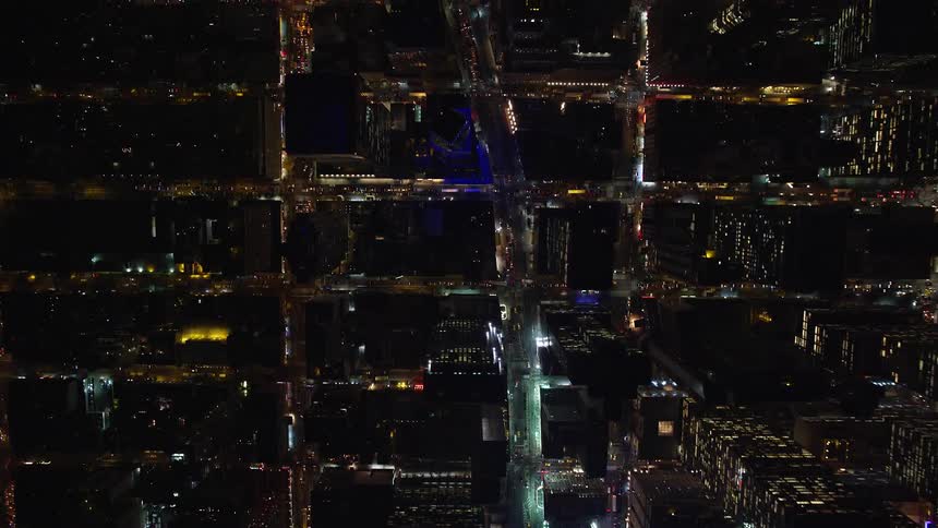 Aerial view of a metropolitan city with illuminated buildings at night