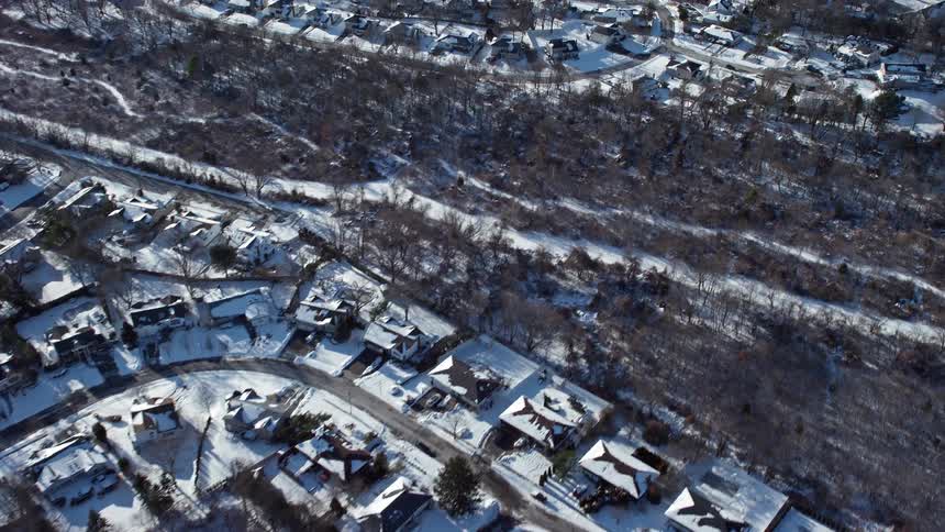Skyline of a neighborhood covered in snow during the day