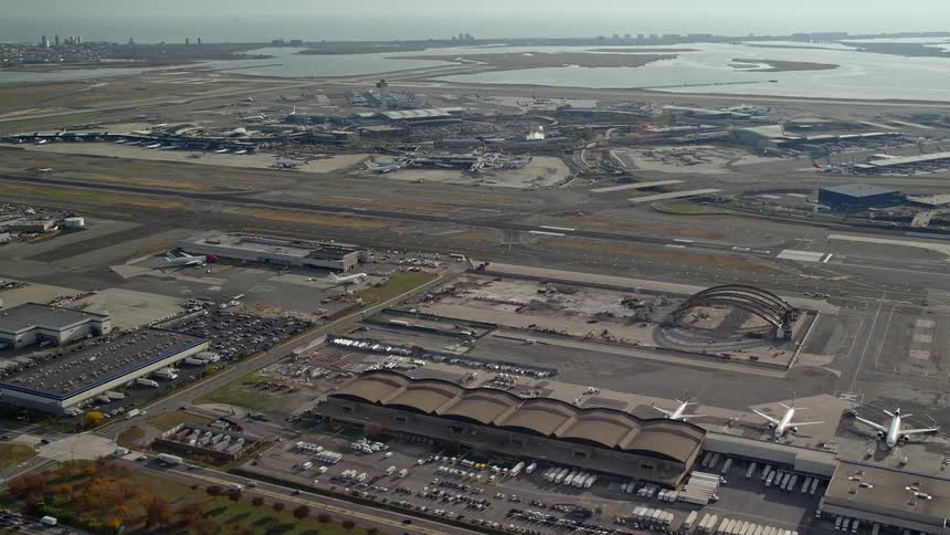 An aerial view of an airport with a huge runway