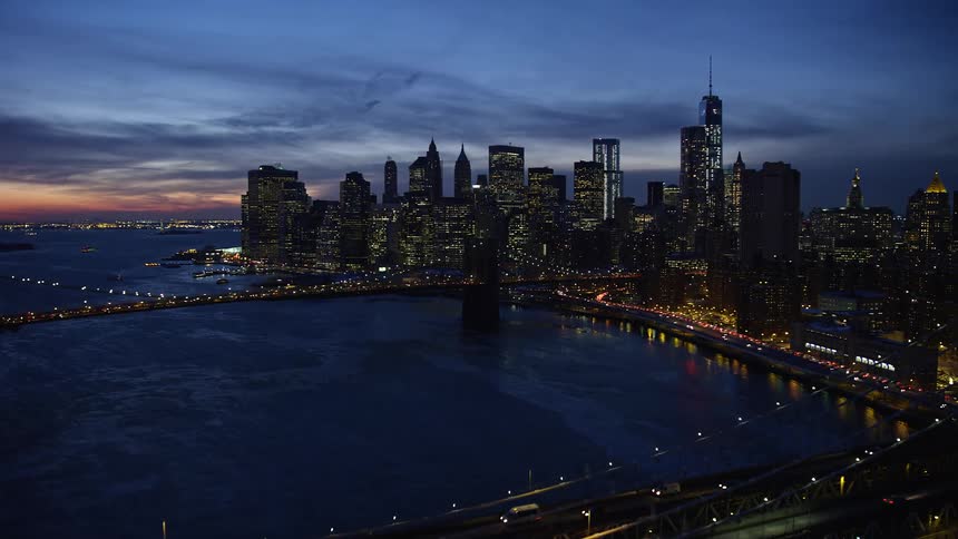Aerial of the brooklyn bridge at night in the illuminated city