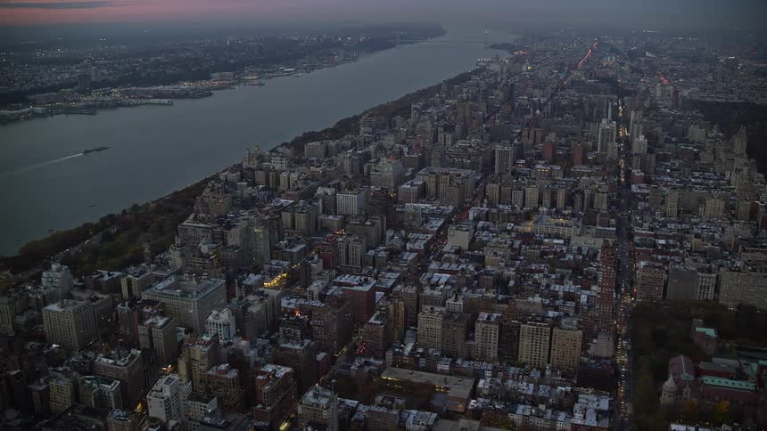 Traffic moves along new york city streets between the river and central park