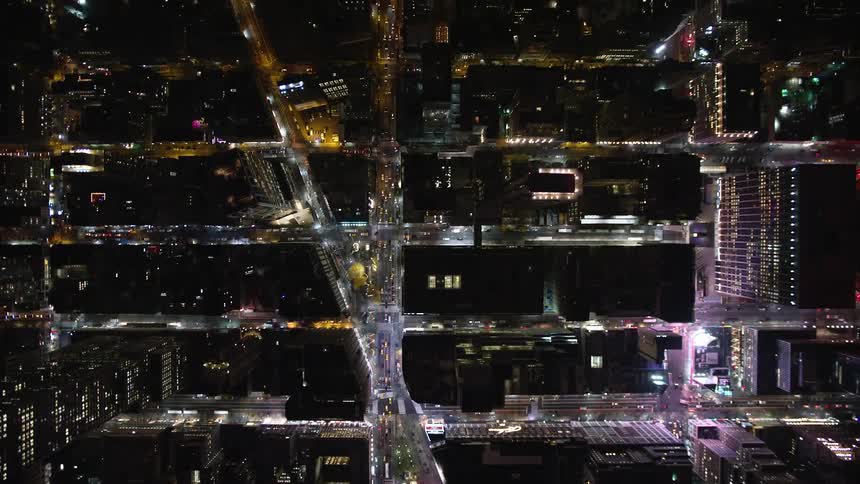Aerial panorama of a nighttime metropolis with streets and traffic