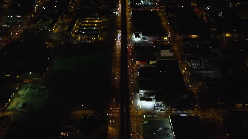 Aerial of traffic driving along city streets at night