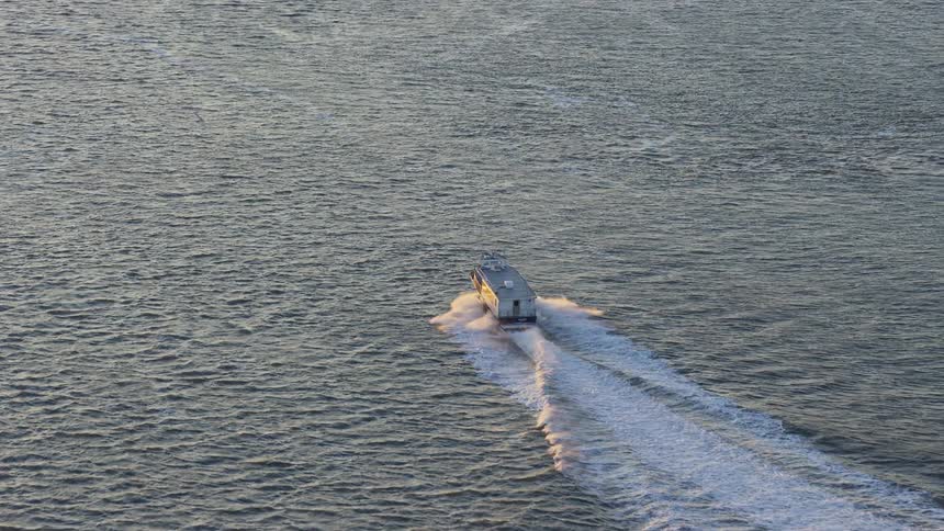 A ship moving on the sea at midday
