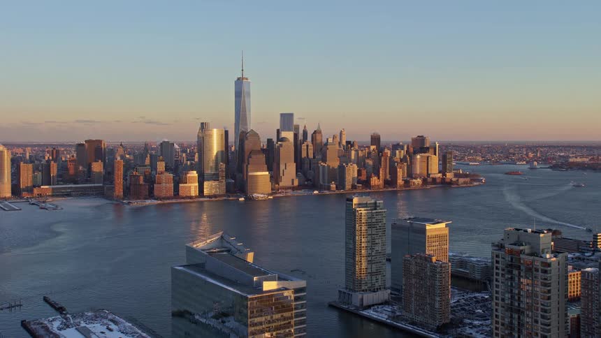 Aerial view of skyscrapers by the seaside with the morning sky