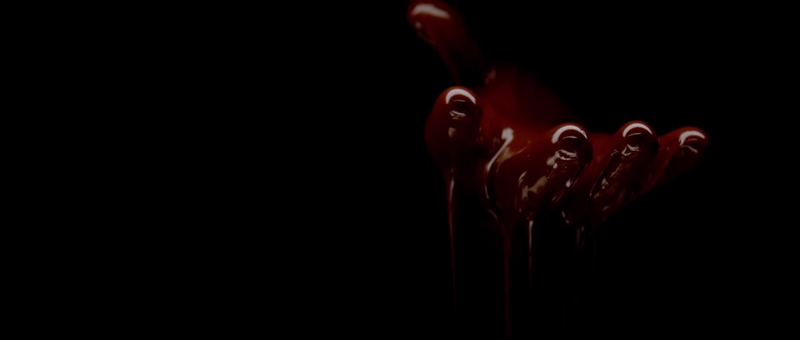 Hand with red paint running between the fingers
