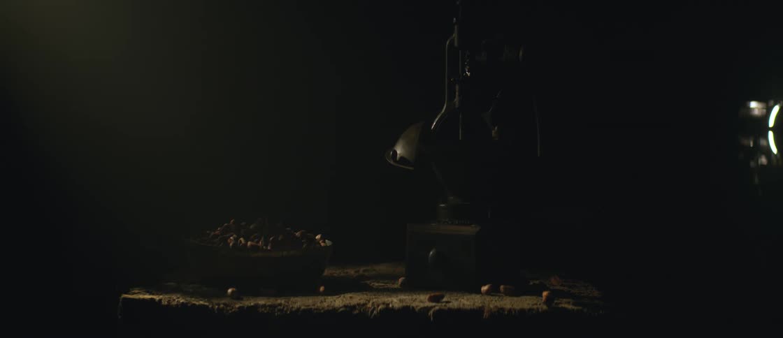 Sunlight reflection under a table with a machine and walnuts on the side